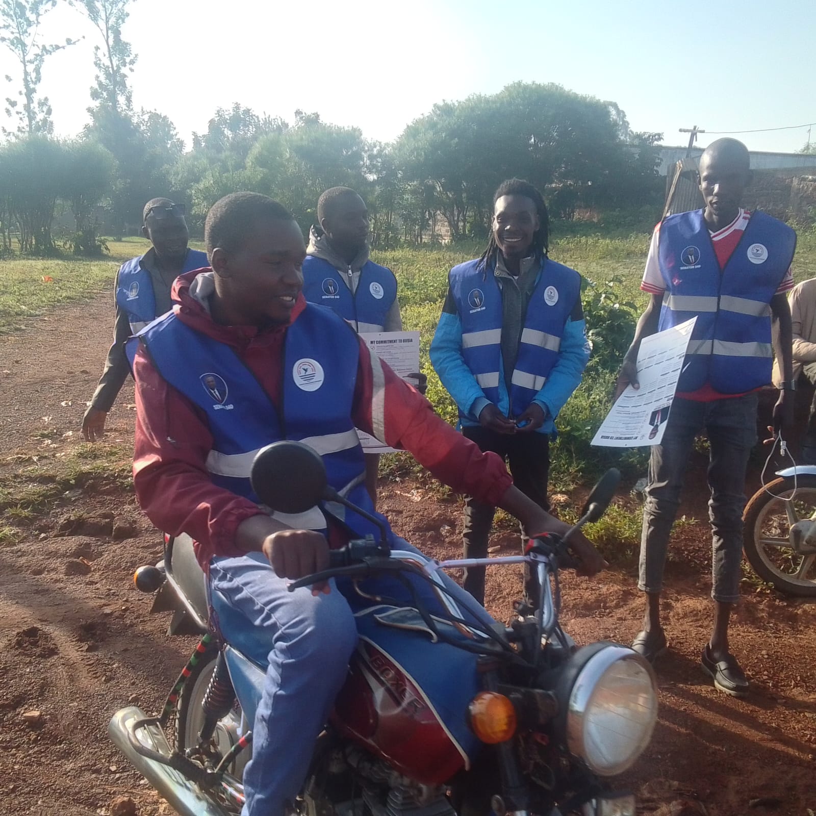 Levi Mulase on the campaign trail — distributing merchandise to Boda Boda riders